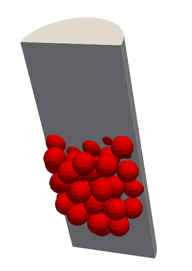 Cutaway through the domain in a 67-pebble packed bed. Pebbles are shown in red, while the fluid region is shown in gray.
