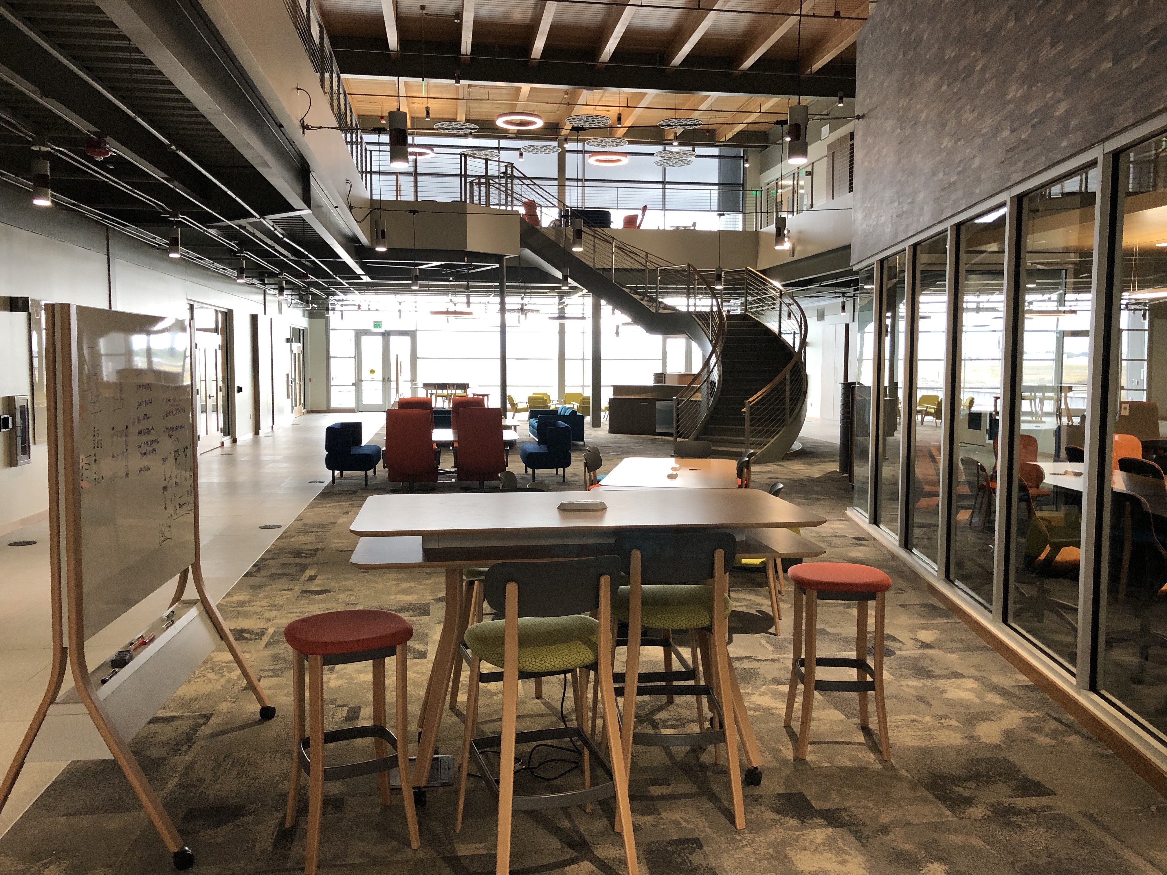 The atrium includes collaboration areas and a view of the Snake River.
